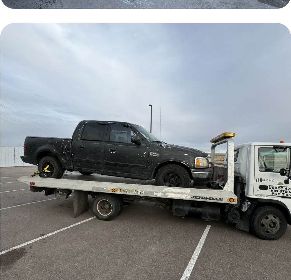 Flatbed tow truck loading an SUV in Colorado Springs